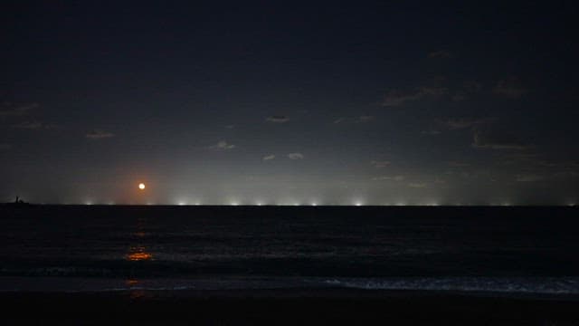 Moonlit Beach with Illuminated Horizon