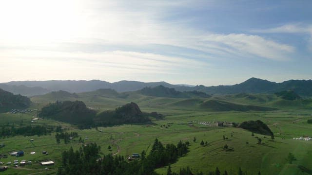 Vast green landscape with distant mountains