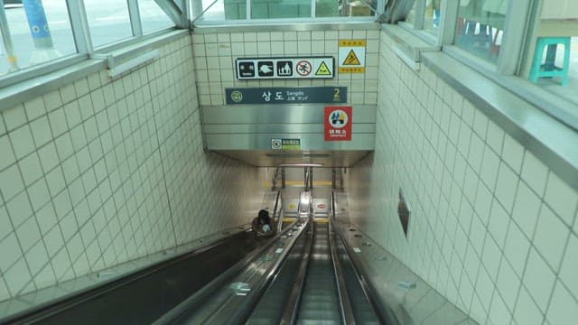 UndergroundSubway Station with Escalators and People