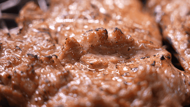 Juicy marinated pork ribs sizzling on grill