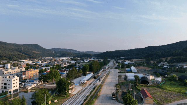 Small train station surrounded by hills