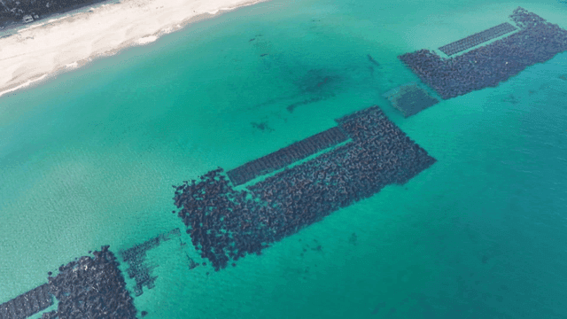 Clear turquoise sea with breakwaters