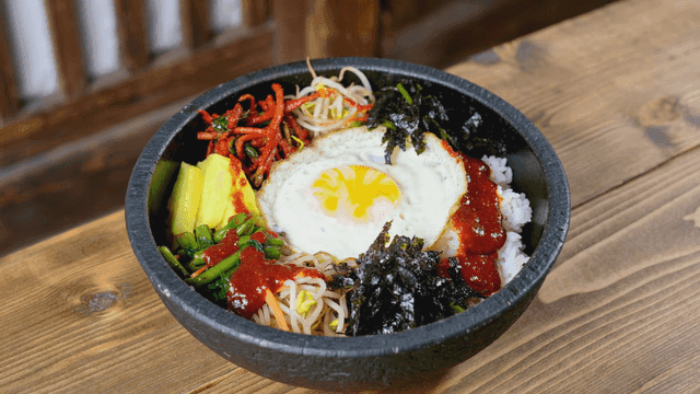 Colorful stone pot bibimbap topped with egg