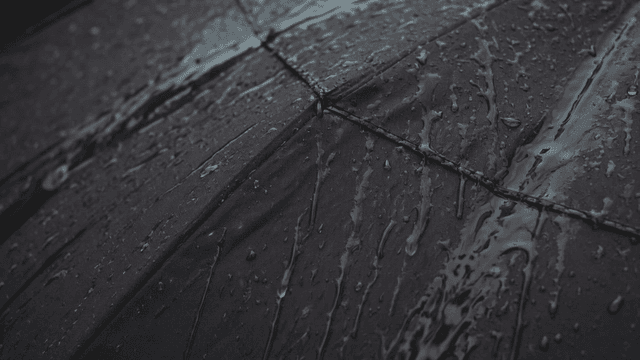 Raindrops on a black umbrella