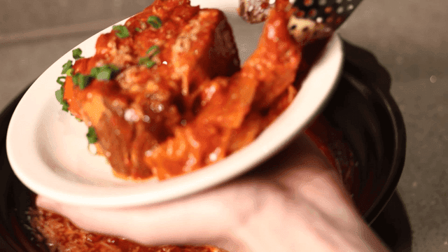 Kimchi stew being served on a plate