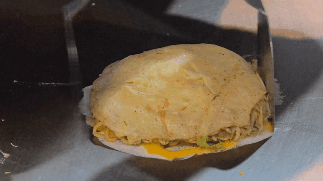 Cooking okonomiyaki on a hot griddle