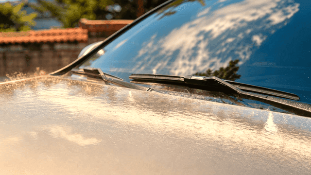 Car windshield reflecting the sky