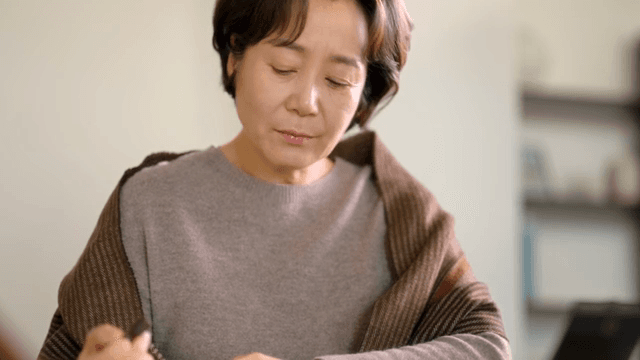 Woman stamping with a blank expression