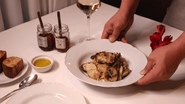 A table set with pasta and wine