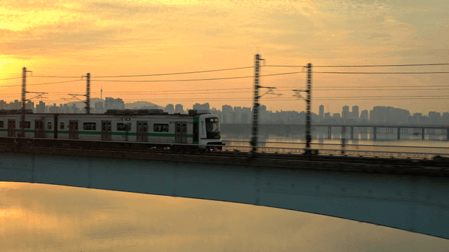 Train crossing a bridge at sunset