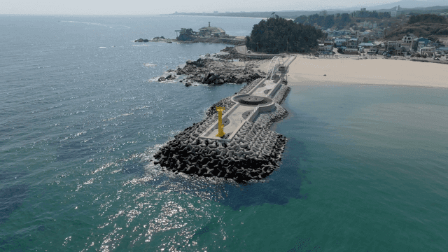 Pier extending into the ocean with a lighthouse