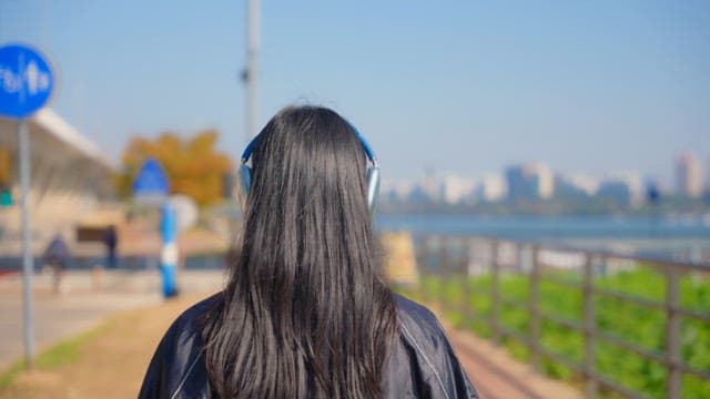 Woman jogging while wearing headphones