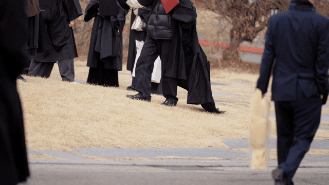 Graduates celebrating on campus with flowers