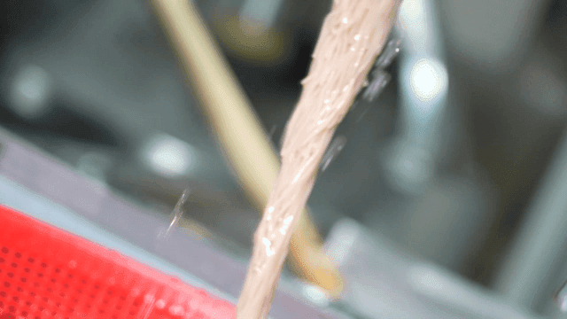 Fresh noodles being rinsed in water