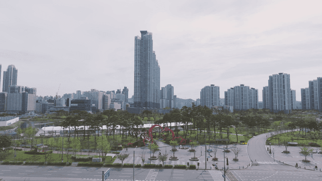 Modern cityscape with tall buildings and park