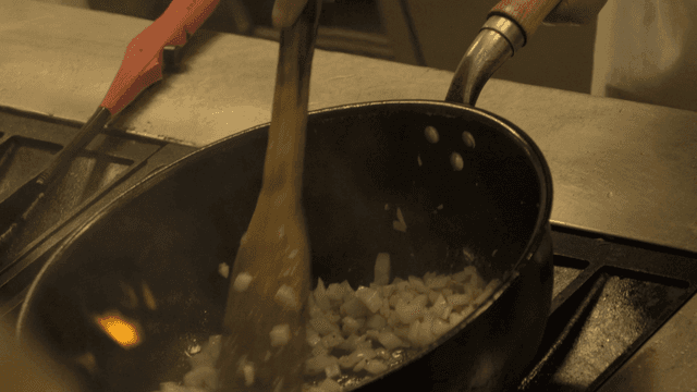 Scene of frying onions in pan
