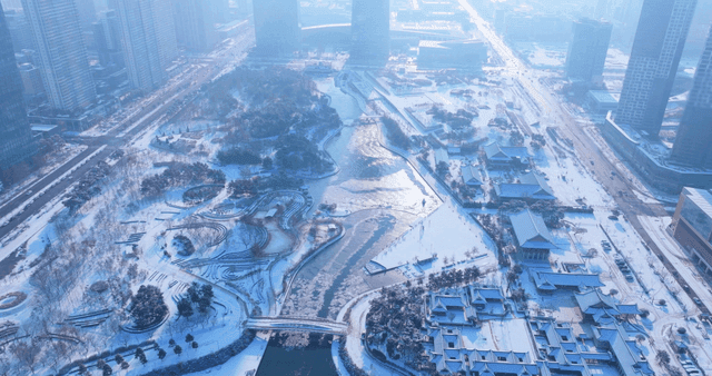 Snow-covered cityscape with a river