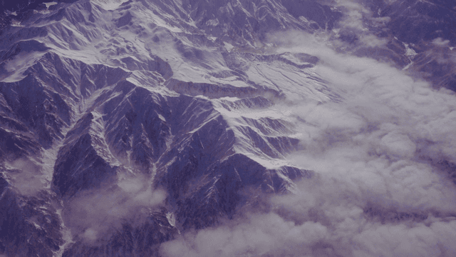 Snow-covered mountains with clouds
