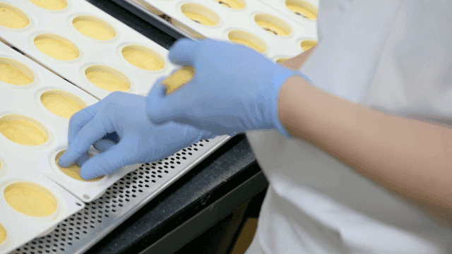 Person preparing pastries with precision