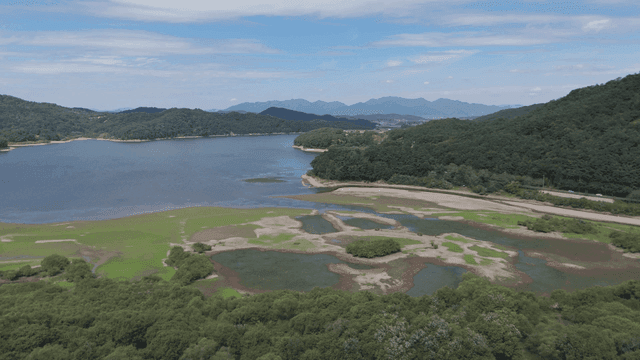 Tranquil lake surrounded by green hills
