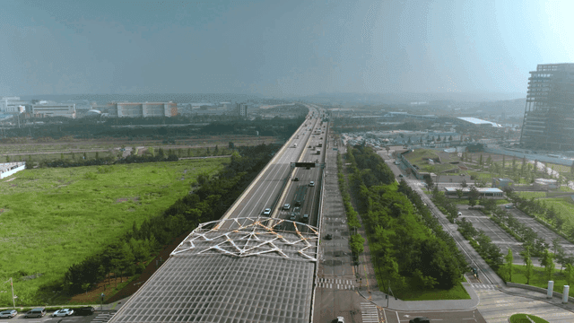 Highway cutting across landscape of green plains