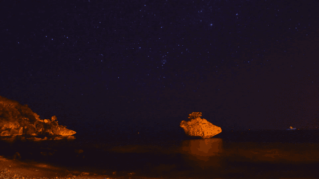 Starry night over a calm beach