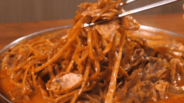 Bite of pork backbone stew with sweet potato stems