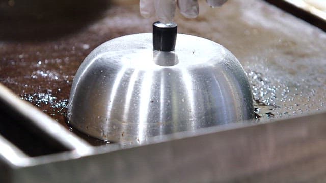 그릴에서 조리 중인 치즈버거 패티