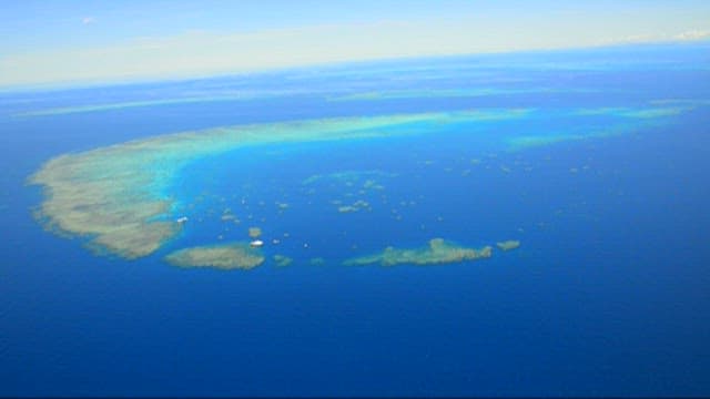 Aerial View of a Peaceful Tropical Coral Reef Island