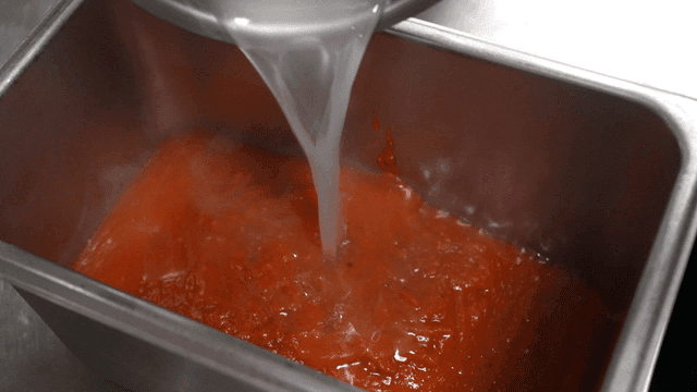 Noodles poured over red tomato sauce