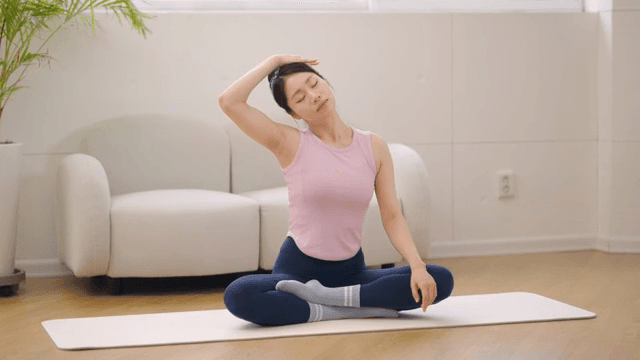 Woman stretching indoors