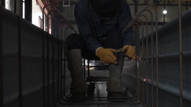 Worker welding inside a metal structure