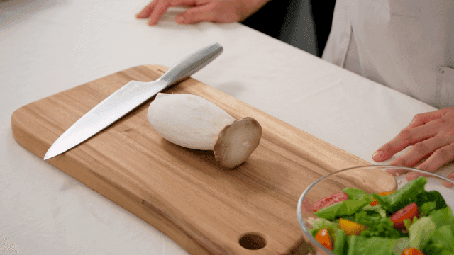 Knife and mushrooms on cutting board