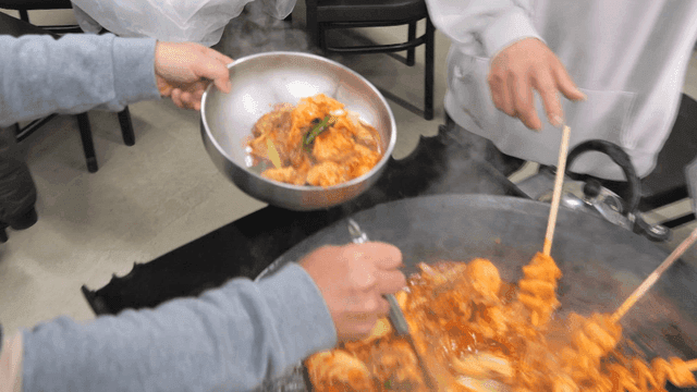 Sight of putting spicy chicken stew into bowl