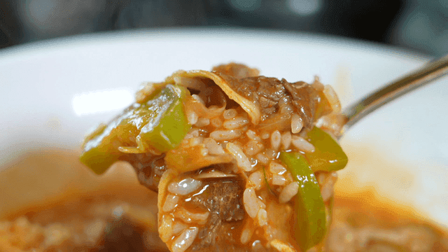 Spoonful of spicy zucchini gochujang stew with rice