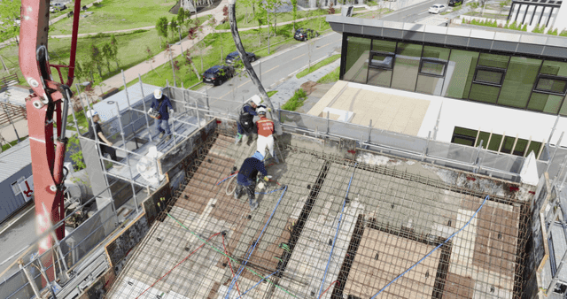 Construction workers pouring concrete