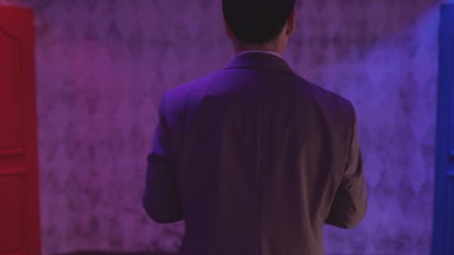 Man in a suit choosing between two doors