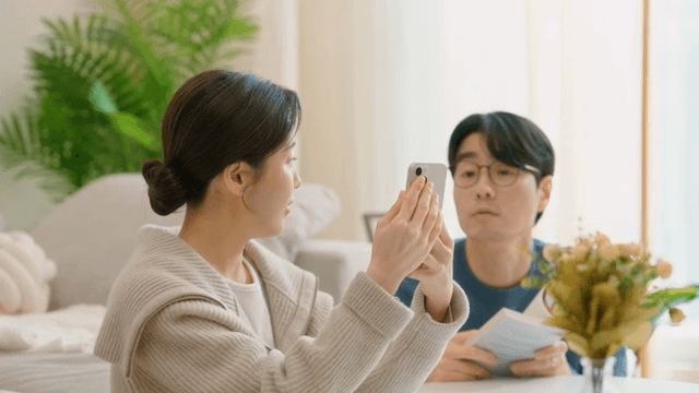 Couple talking while looking at their smartphones