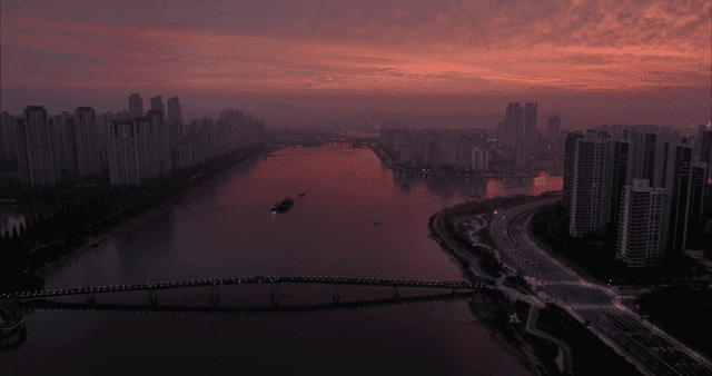 City skyline at dusk with a river