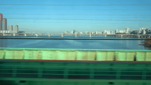 View of a city skyline from a moving train