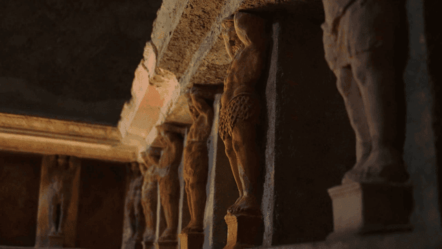 Ancient stone sculptures in a dimly lit room