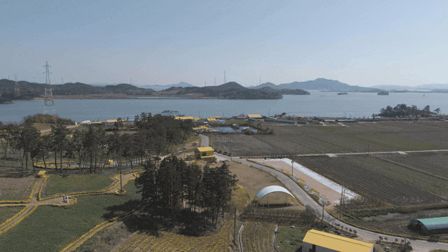 Large farmland with view of coast
