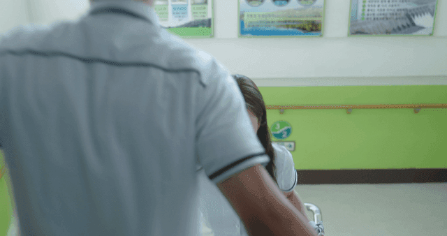 Two students brushing shoulders while passing on school stairs