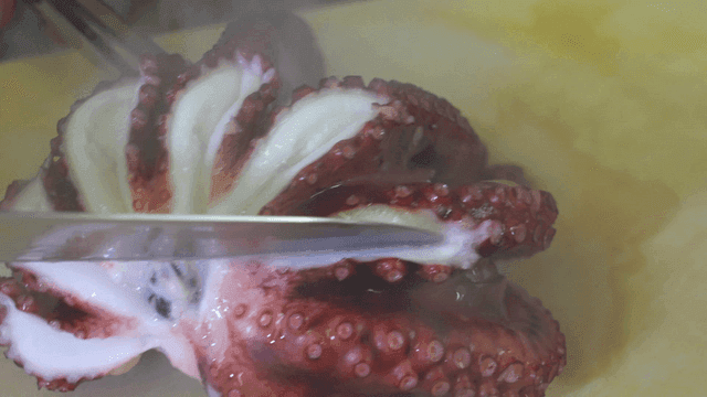 Knife for cutting octopus on cutting board
