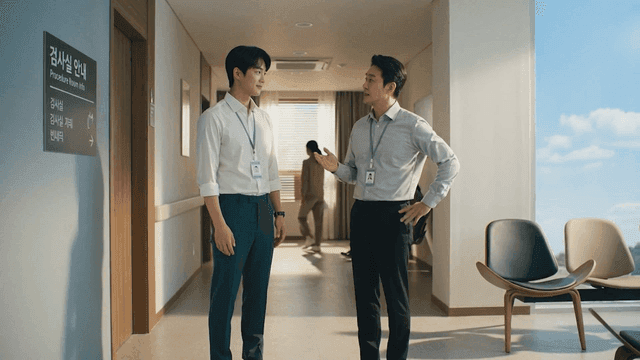 Two professionals discussing in a hospital corridor