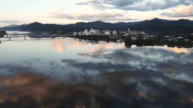 Tranquil river reflecting city landscape