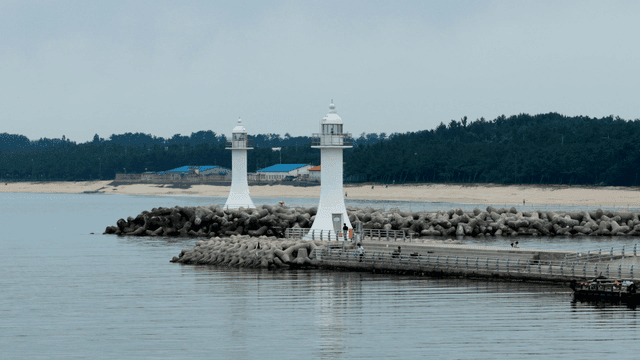 Two lighthouses by the calm sea