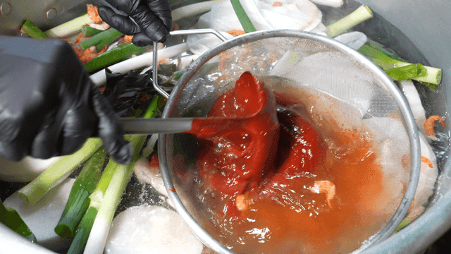 Gochujang strained through sieve into large pot
