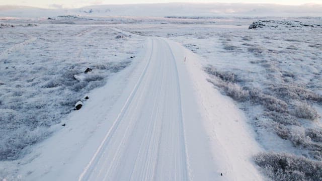 Car driving on a snowy road in winter