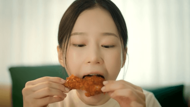 Woman enjoying spicy seasoned chicken